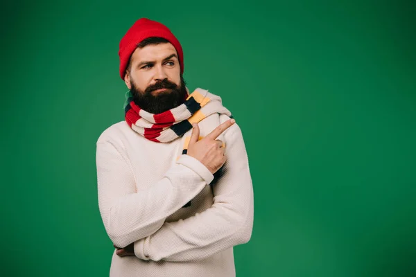 Handsome Ill Man Hat Scarf Pointing Aside Isolated Green — Stock Photo, Image