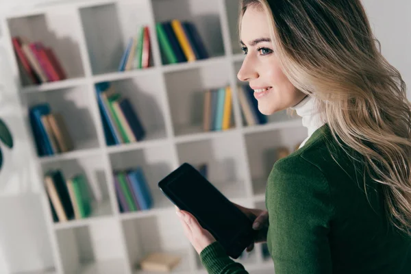 Mujer Alegre Sosteniendo Libro Con Pantalla Blanco Cerca Estantería Casa — Foto de Stock