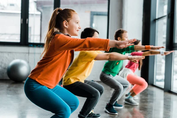 Concentrated Kids Doing Squats Training Gym — Stock Photo, Image