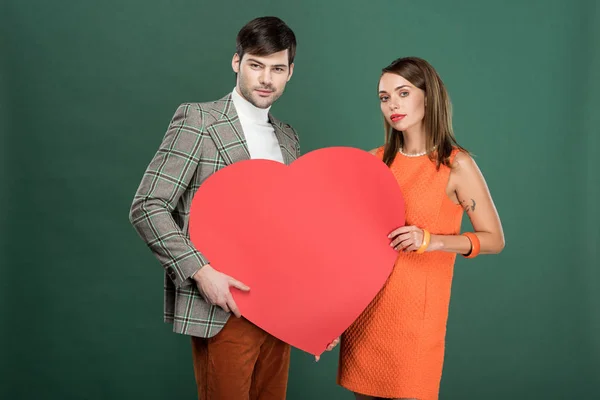 Beautiful Couple Holding Heart Shaped Paper Card Looking Camera Isolated — Stock Photo, Image