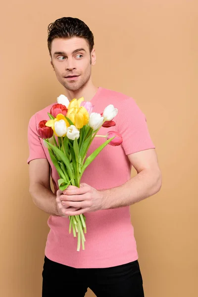 Surprised Man Holding Bouquet Flowers Isolated Beige — Stock Photo, Image