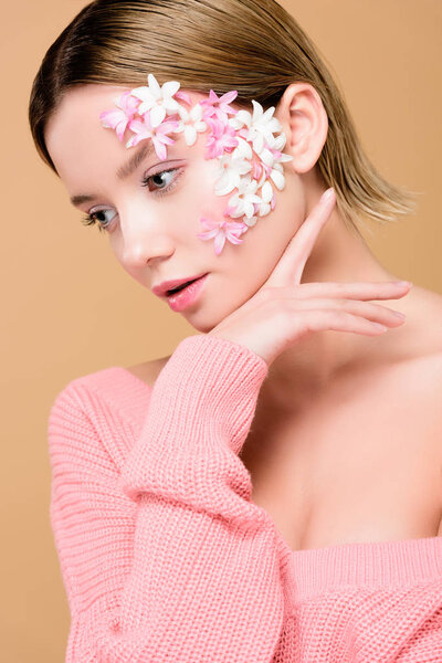 beautiful girl with flowers on face isolated on beige