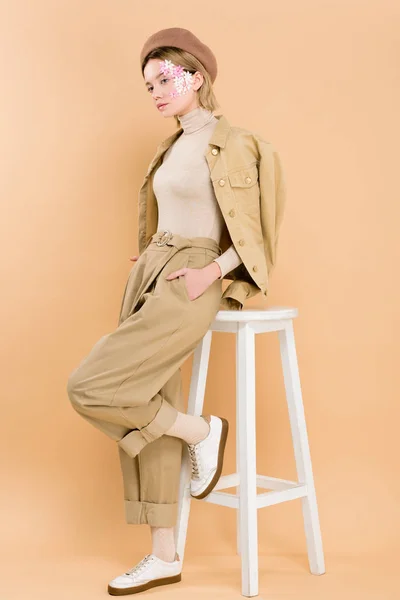 Stylish Woman Beret Standing Hand Pocket Chair Isolated Beige — Stock Photo, Image