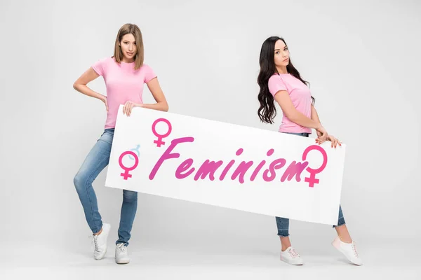 Attractive Women Holding Large Sign Feminism Lettering Grey Background — Stock Photo, Image
