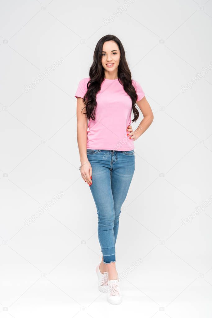 attractive girl standing and smiling isolated on grey