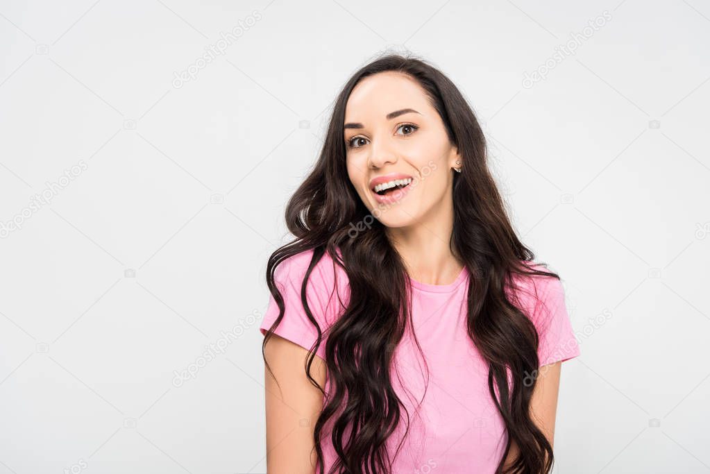 happy girl standing and smiling isolated on grey