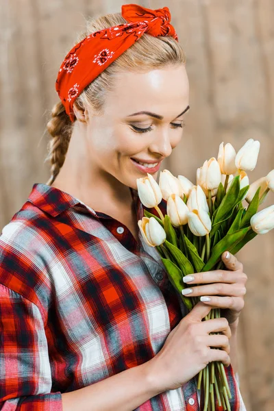 Cheerful Woman Smiling While Smelling Tulips — Stock Photo, Image