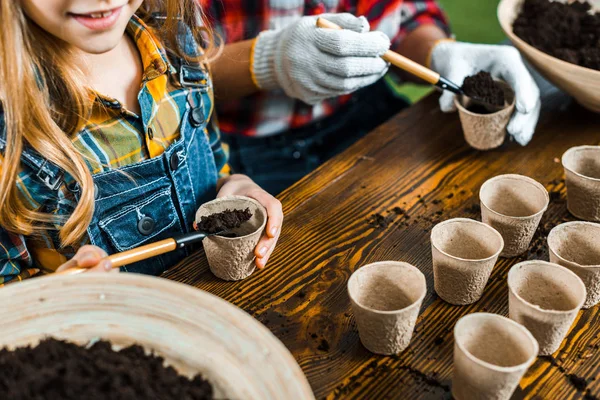 Cropped View Mother Daughter Small Paper Cups Shovels Ground — Stock Photo, Image