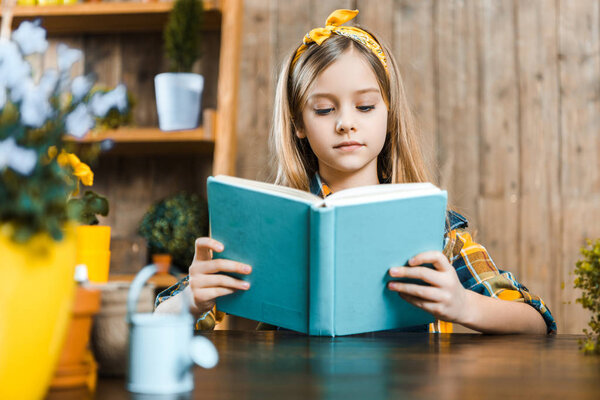 selective focus of cute kid reading book 
