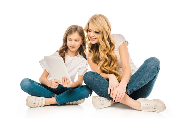 美丽的女人和可爱的孩子坐在地板上 并使用数字平板电脑在白色背景 — 图库照片
