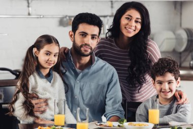 evde fotoğraf makinesi vasıl bakarken gülümseyerek mutlu bir İspanyol Aile