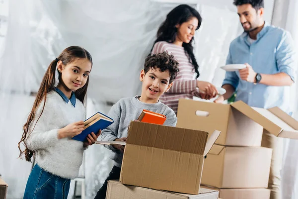 Selective Focus Cute Kids Holding Books While Parents Standing Boxes — Stock Photo, Image