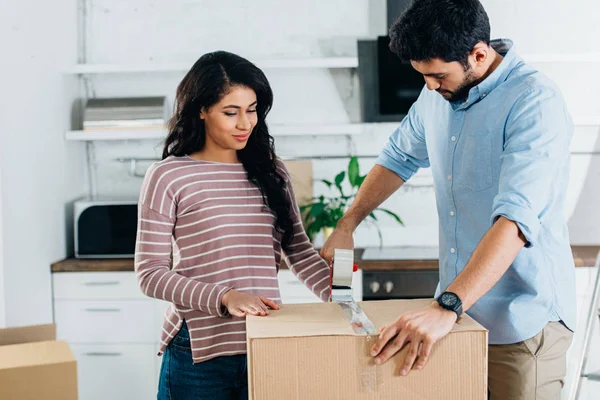 Happy Latin Couple Packing Boxes While Moving New Home — Stock Photo, Image