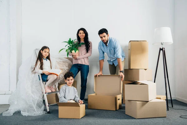 Cheerful Latin Family Standing Boxes While Moving New Home — Stock Photo, Image