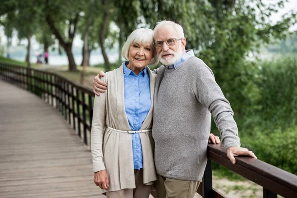 Selective Focus Happy Senior Couple Hugging While Standing Wooden Bridge — Stock Photo, Image