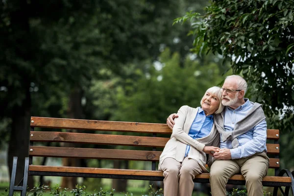 Happy Senior Couple Hugging Holding Hands While Resting Wooden Bench — Stock Photo, Image