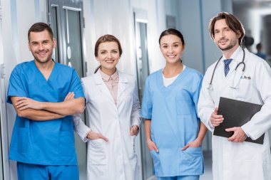 Laughing doctors and nurses looking at camera clipart