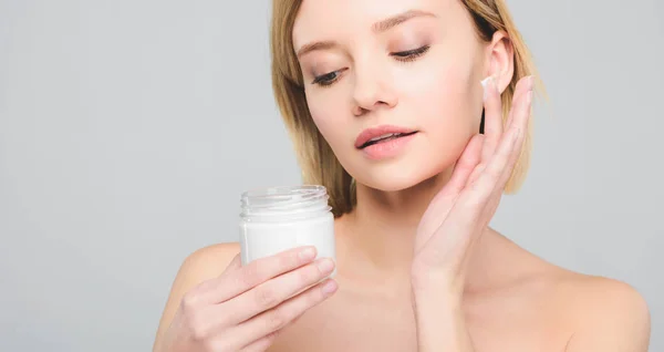 Tender Girl Applying Cosmetic Cream Face Holding Plastic Container Isolated — Stock Photo, Image