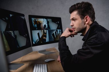 handsome guard in uniform looking at computer monitor clipart