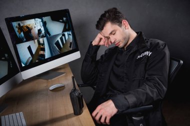 handsome guard in uniform sleeping at workplace  clipart