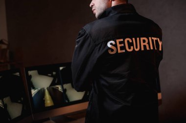 cropped view of guard in black uniform at workspace  clipart