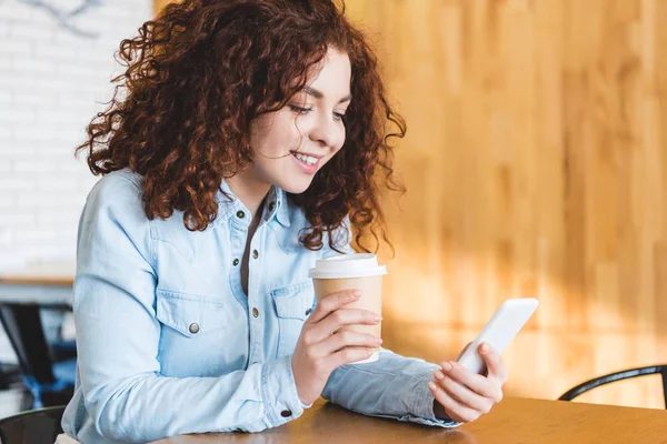 Hermosa Sonriente Mujer Sosteniendo Una Taza Papel Usando Teléfono Inteligente —  Fotos de Stock