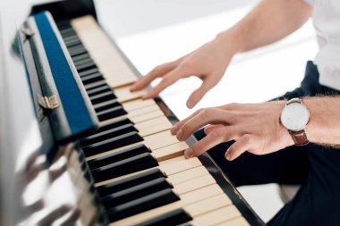 selective focus of musician man playing piano  clipart
