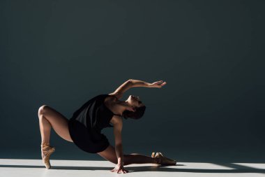 graceful young ballerina in black dress dancing in sunlight  clipart