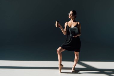 gazete ve kağıt Kupası ile poz gözlük içinde genç balerin 