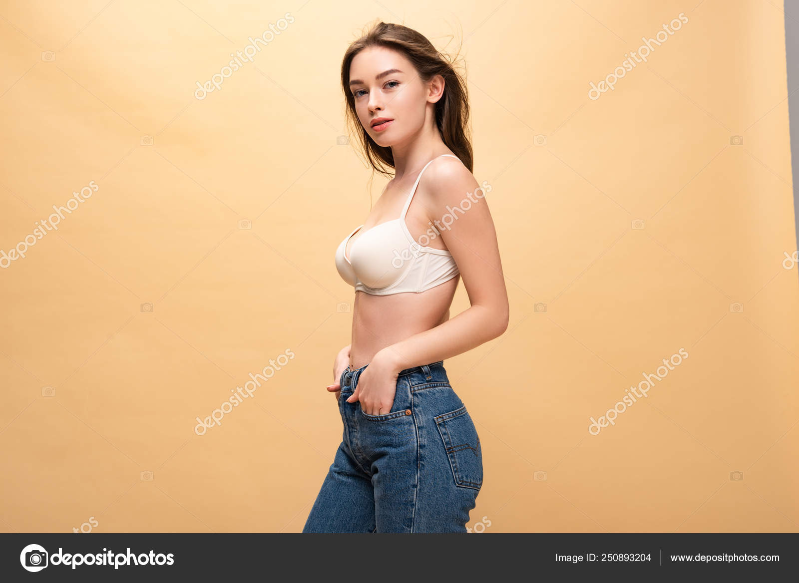 Pensive Girl Blue Jeans Hands Pockets Looking Camera Isolated Stock Photo by ©AllaSerebrina 250893204