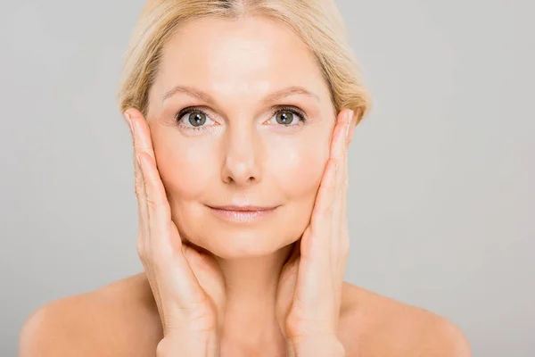 Attractive Blonde Mature Woman Touching Her Face Looking Camera Isolated — Stock Photo, Image