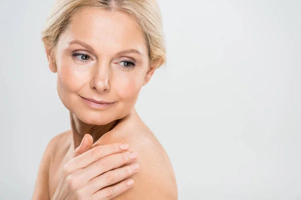 Attractive Blonde Mature Woman Looking Away Touching Her Shoulder Grey — Stock Photo, Image