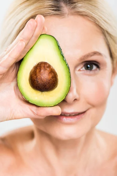 Selective Focus Beautiful Mature Woman Holding Avocado Looking Camera Isolated — Stock Photo, Image