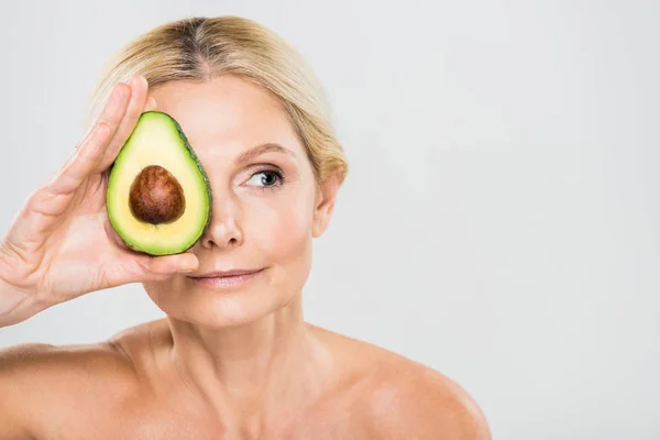 Beautiful Mature Woman Holding Avocado Looking Away Isolated Grey — Stock Photo, Image