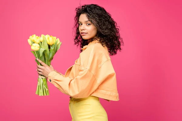 Séduisante Afro Américaine Tenant Des Tulipes Jaunes Isolées Sur Cramoisi — Photo