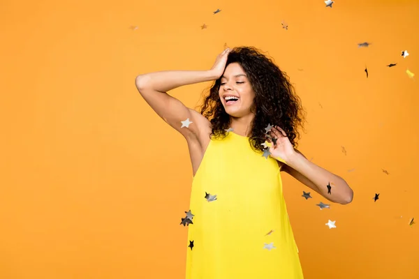 Cheerful Curly African American Woman Smiling Shiny Confetti Stars Orange — Stock Photo, Image