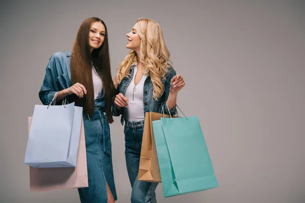 Glückliche Blonde Und Brünette Frauen Jeanskleidung Die Lächeln Und Einkaufstüten — Stockfoto