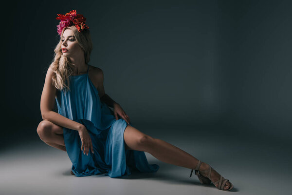 beautiful and blonde woman in elegant dress and wreath looking away 