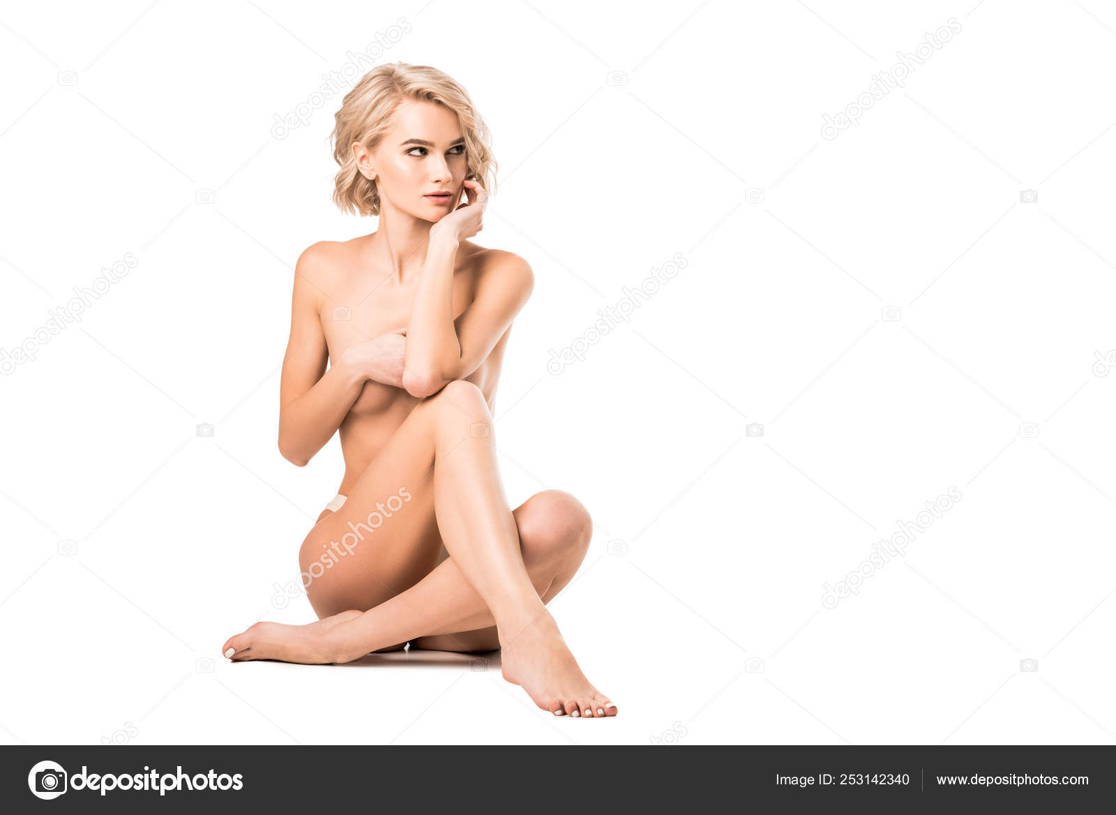 Portrait of naked woman covering breasts with towel against white background stock photo