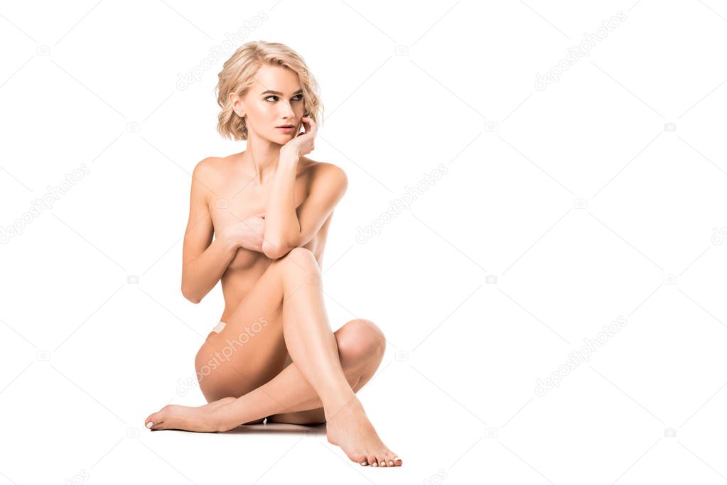 beautiful half-naked young woman covering breasts isolated on white with copy space