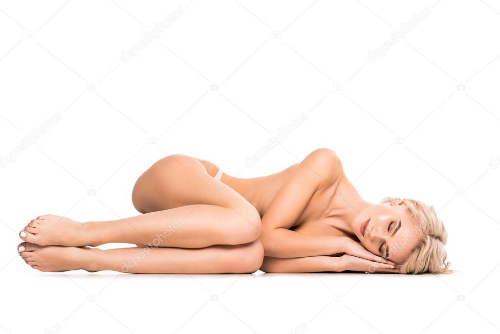 beautiful half-naked young woman lying with eyes closed isolated on white with copy space