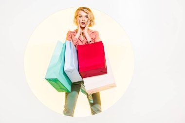 surprised stylish girl looking at camera and holding shopping bags on white with yellow circle clipart