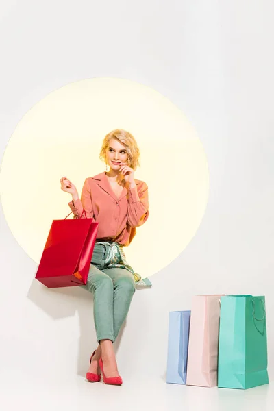 Beautiful Stylish Girl Sitting Yellow Circle Smiling Holding Shopping Bag — Stock Photo, Image