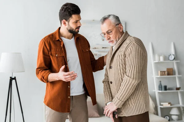 Handsome Bearded Man Gesturing While Looking Sad Senior Father — Stock Photo, Image
