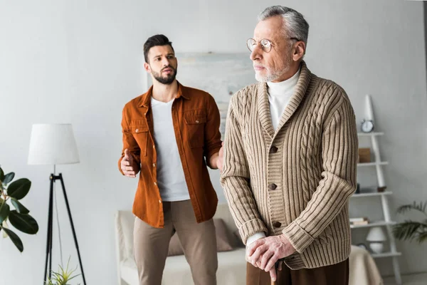 Handsome Bearded Son Gesturing While Looking Sad Senior Father — Stock Photo, Image