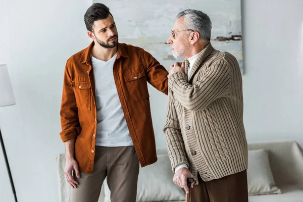 Handsome Bearded Son Putting Hand Shoulder Sad Senior Father Glasses — Stock Photo, Image