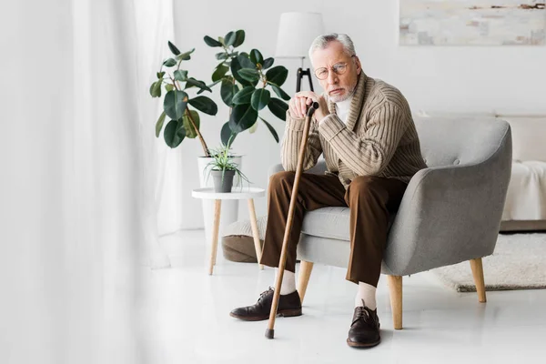 Upset Retired Man Sitting Armchair Walking Cane Looking Camera — Stock Photo, Image