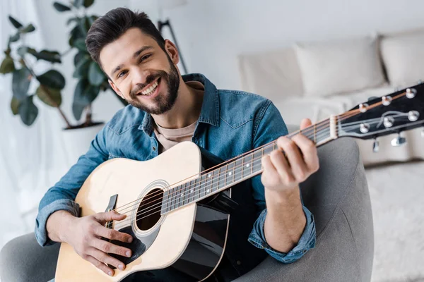 Cheerful Bearded Man Playing Acoustic Guitar Home — Stock Photo, Image