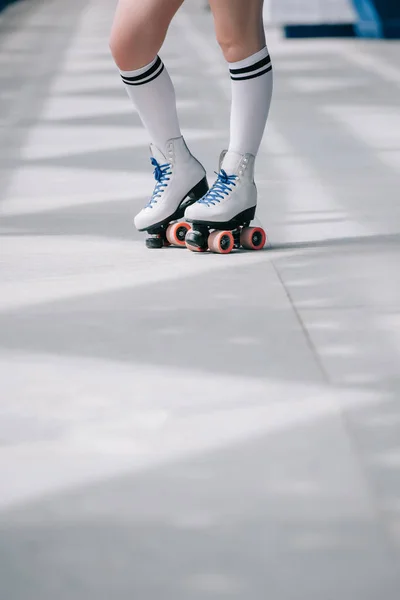 Partial view of woman in white high socks and retro roller skates — Stock Photo