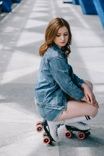 Side view of stylish woman in denim clothing, high socks and retro roller skates — Stock Photo